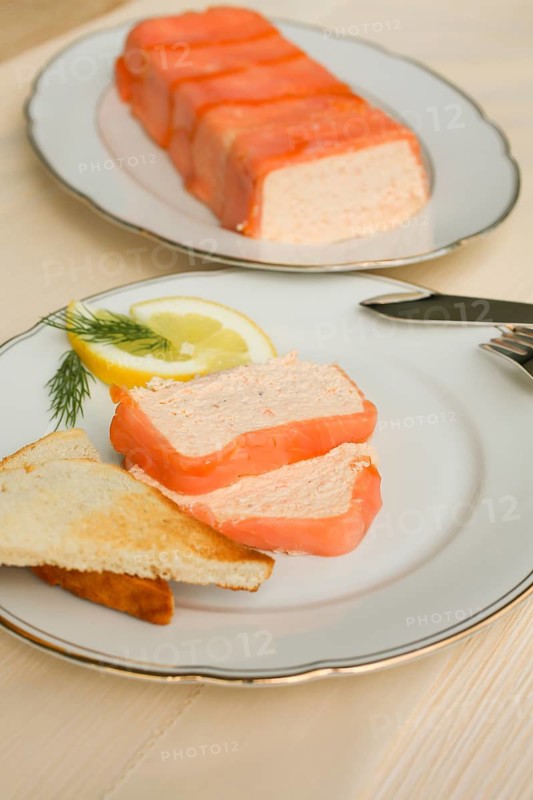Southern German cuisine, salmon trout terrine arranged on a plate, salmon terrine with trout fillets, fish dish, salmon fillets, smoked salmon, starter, fine dining, Sunday crockery with gold rim, grandma's service, lemons, dill, fish cutlery, toast, food photography, studio, Germany