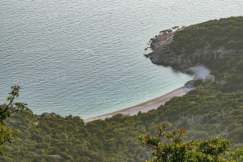 View from Lubenice across the sea with coastal landscape and bays on a sunny day at sunset on the island of Cres, Croatia