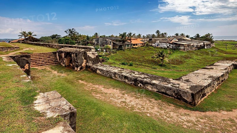 Ruins of a fortress with grass and palm trees under a blue sky, The fortress of Galle in Sri Lanka