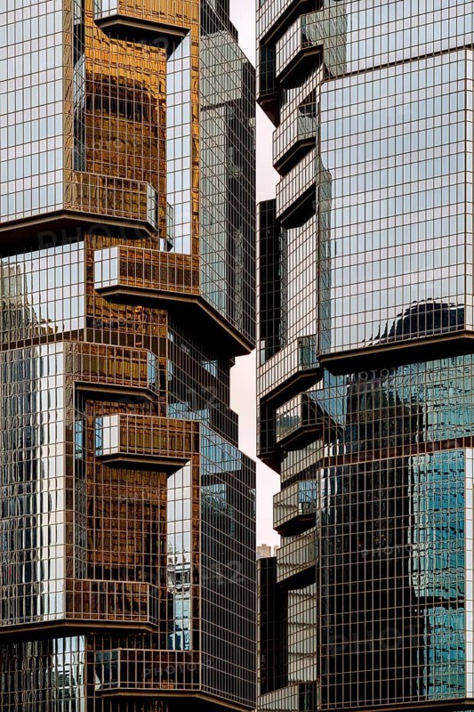 Close-up view of modern skyscrapers in Hong Kong, showcasing the intricate designs and reflective glass facades that characterize the city's dynamic skyline