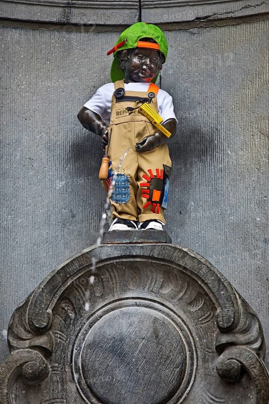 Bronze statue Manneken Pis by Jérôme Duquesnoy, fountain figure of a urinating boy in costume, landmark, Brussels, Belgium