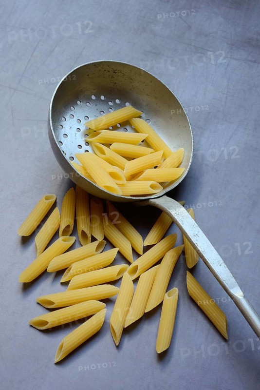 Pasta, Italian penne in a sieve ladle
