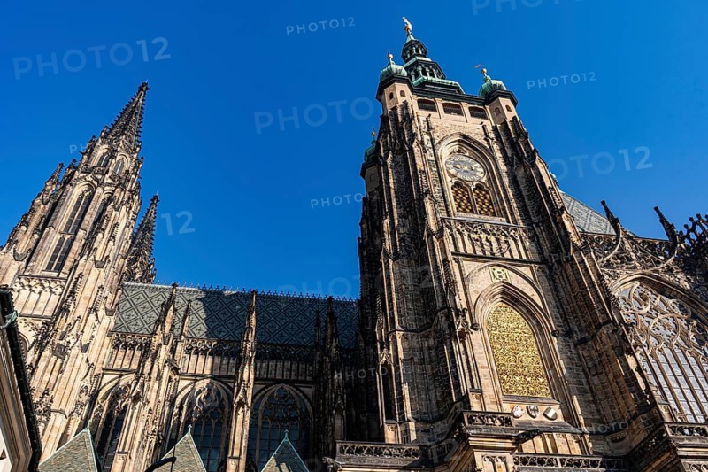 Stunning view of St. Vitus Cathedral in Prague, showcasing intricate Gothic architecture under a clear blue sky, highlighting its historical significance and grandeur
