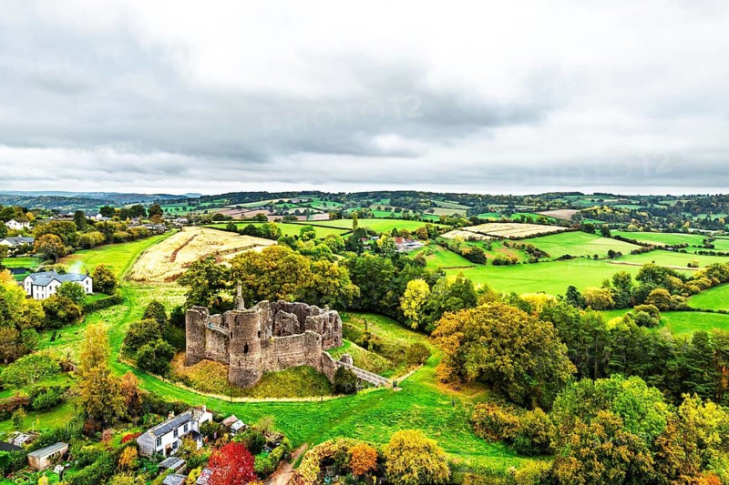 Autumn Colours over ruins of Grosmont Castle from a drone, Grosmont, Monmouthshire, Wales, UK