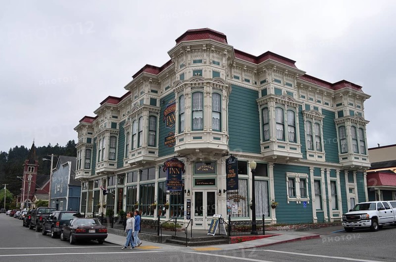 Victorian inn with green-blue façade and ornate details on a cloudy day, Ferndale, California, USA