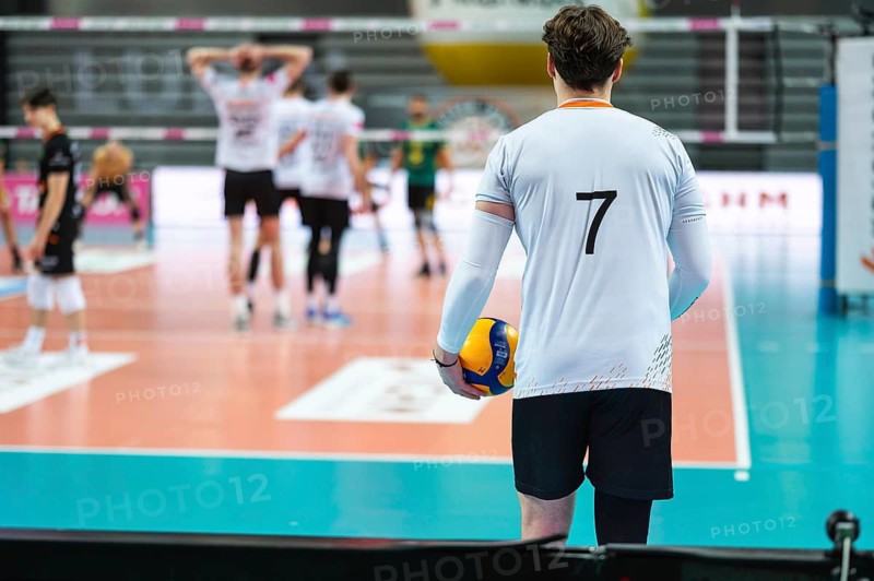 Volleyball player serves ball during the match