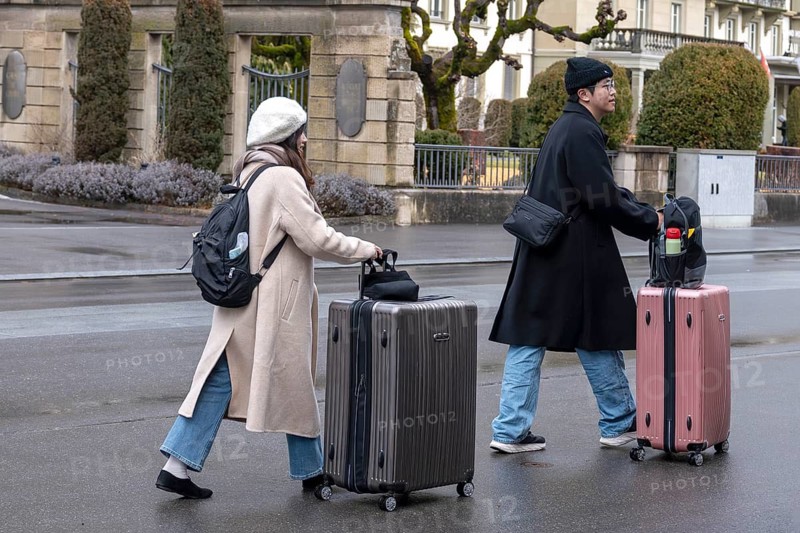 Tourists with wheeled suitcase, Interlaken, Switzerland