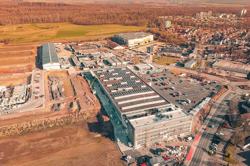 Urban building complex with solar panels in an urban autumn setting, PV Bau Auf OBI Bau Markt, Mühlacker, Enzkreis, Germany