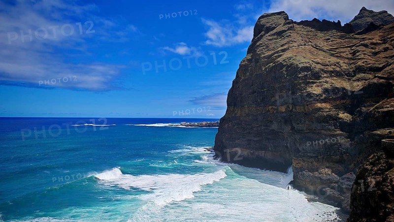 Steep cliff above the blue ocean with powerful waves under a clear sky, hiking, Santo Antao, Cabo Verde, Cape Verde, Cape Verde