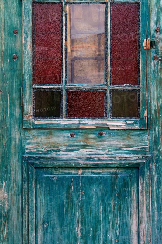Old wooden door with glass windows and worn patina, Turkey