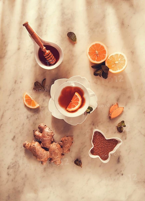 Ginger tea, with lemon, mint and honey, on a marble table, top view, sunlight, no people, selective focus