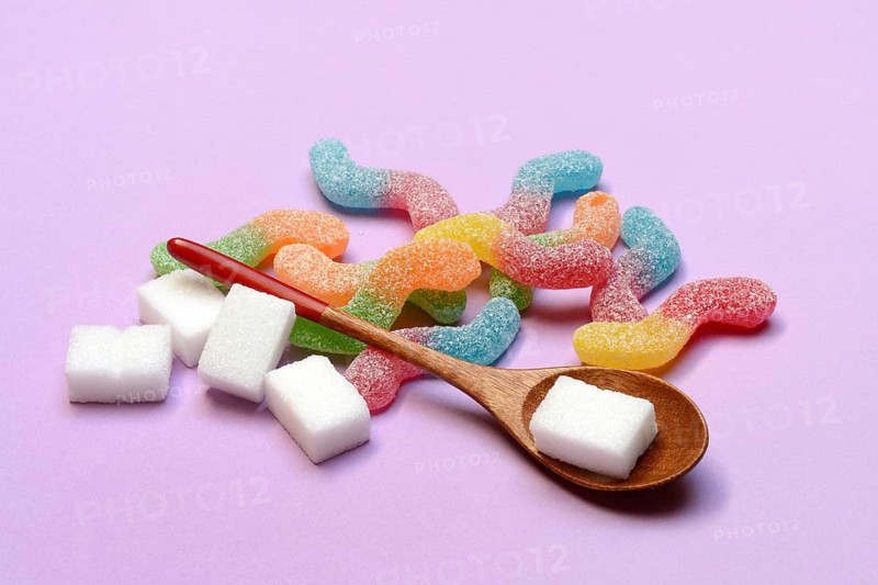 Lots of colorful jelly candies and sugar cubes, sugar consumption