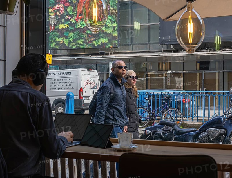 View through the window of a café of passers-by on Friedrichstraße in Mitte, Berlin, Germany