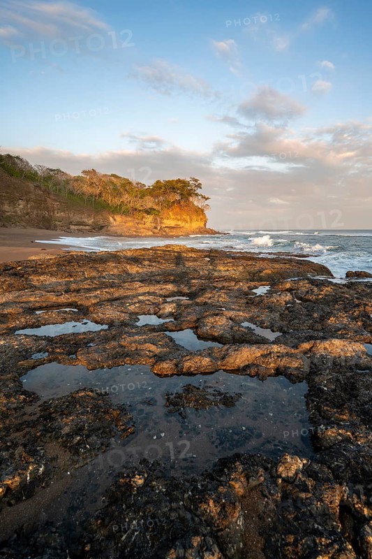 Rocks on the beach, Playa Cocalito, coastal landscape at sunset, Pacific coast, Nicoya Peninsula, Puntarenas Province, Costa Rica