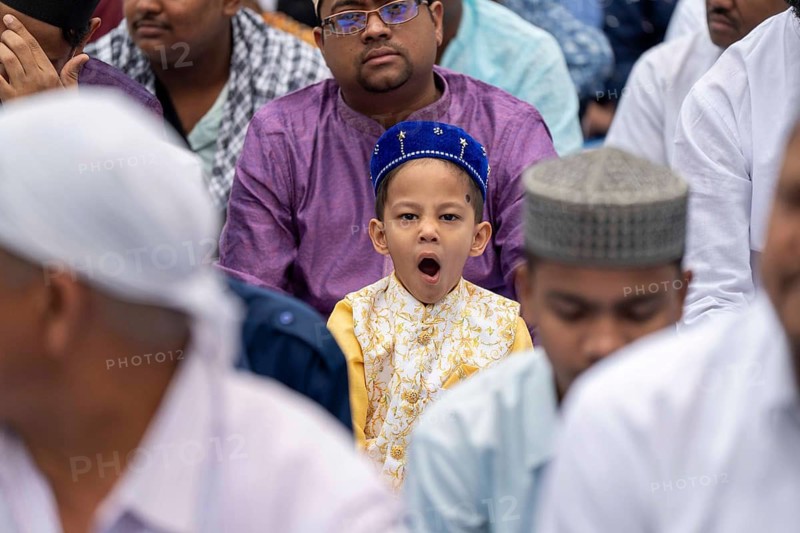 A Muslim child with elders attend to Eid al-Fitr prayer at Eidgah, on March 21, 2026 in Guwahati, India. Muslims make up a sizeable minority of India's population and celebrate Eid along with muslims across the world at the end of Ramadan