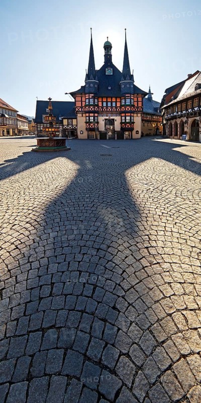 Market square with town hall and long shadow in the backlight, Wernigerode, Harz, Saxony-Anhalt, Germany