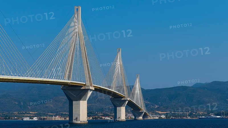 Wide angle view of a long bridge in front of a hilly landscape, Rio-Antirrio cable car bridge, Patras, Peloponnese, Greece