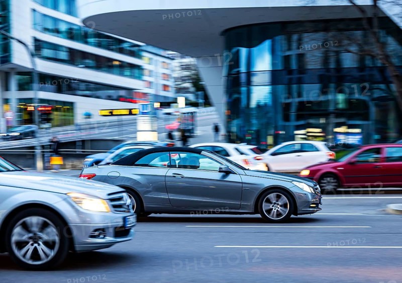 Car at night in front of an urban environment with modern architecture, driver. Mercedes E-class. Stuttgart, Baden-Württemberg, Germany