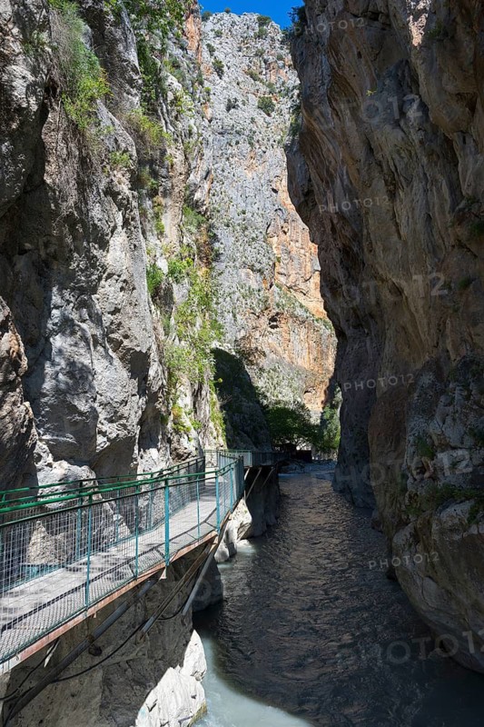 Narrow gorge with steep rock walls and a walkway over a flowing river, Saklikent Gorge, Saklikent National Park, Antalya Province, Turkey