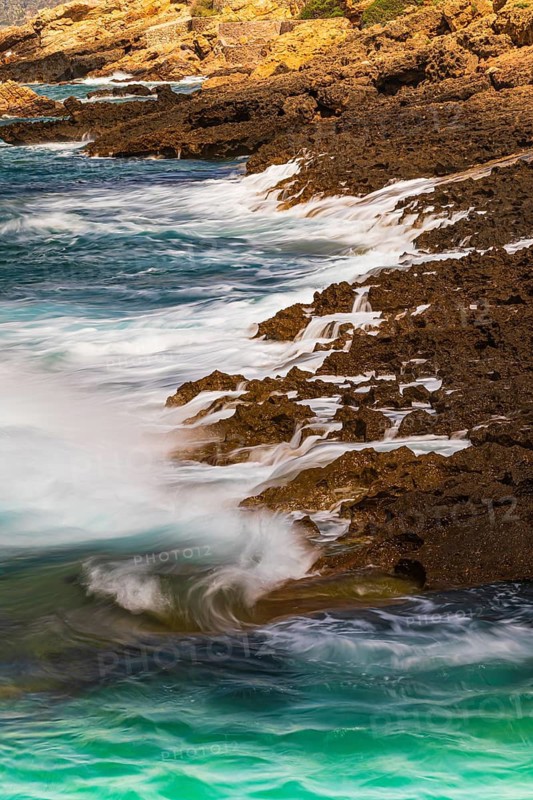 Rugged rocky coastline and foaming spray, on Stecci beach, near Capoliveri, Elba Island, Tuscan Archipelago National Park, Tuscany, Italy