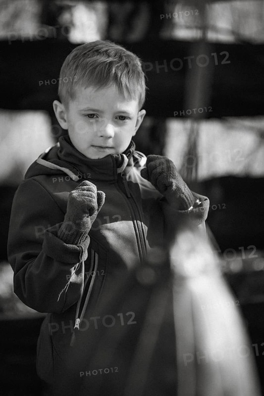 Portrait of a boy practicing boxing outdoor.