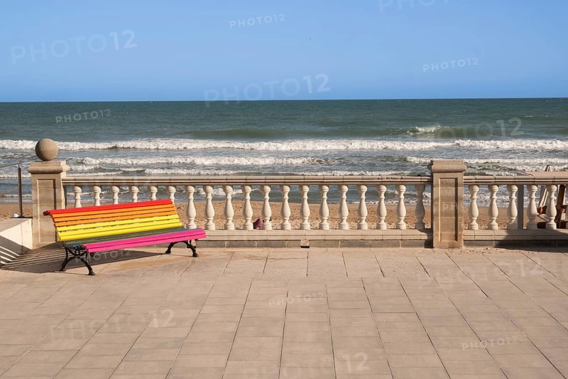 Empty colourful bench on the promenade in Sitges, Spain