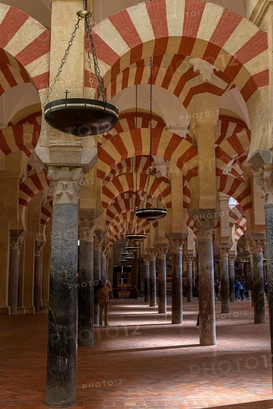 Cathedral Mosque of Cordoba (Mezquita-Catedral), architecture with repeated arches and chain lamps in Moorish style, Cordoba, Andalusia, Spain