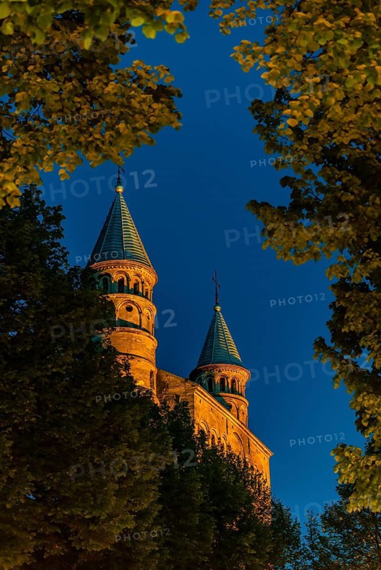 Basilica of Our Lady, Maastricht, Netherlands, The illuminated towers rise above the surrounding trees on a clear night