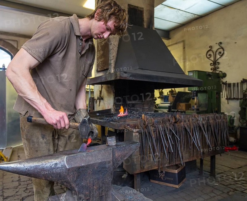 A blacksmith forging, working at the Ehnert forge in Dresden-Bühlau, Saxony, Germany