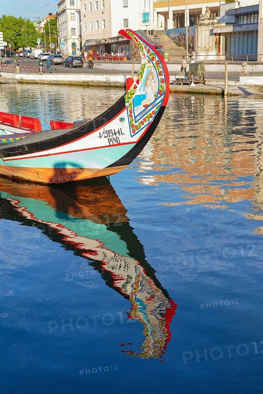 Traditional Moliceiro boat reflected in the water, Aveiro, Portugal