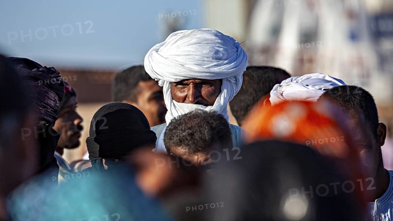 Male person with turban in a crowd at a market place, The traditional Tuareg at the Tamanrasset Festival in the Sahara in Algeria