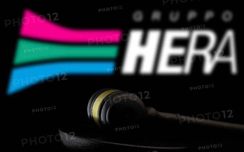 Court gavel in front of the Gruppo hera logo. Hera spa is a multiutility company
