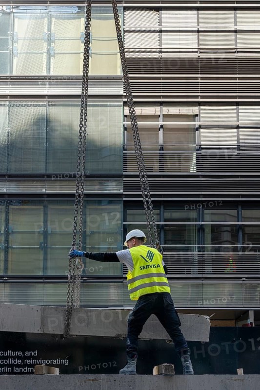 Loading concrete slabs onto a truck trailer using a construction crane, Berlin, Germany