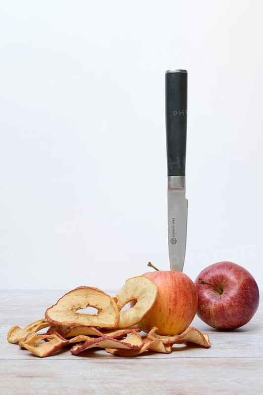 Apple with knife and apple rings, dried fruit