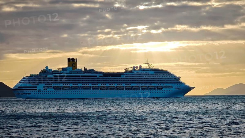 Large cruise ship, Costa Favolosa, on the sea at sunset with atmospheric clouds, Mindelo, Sao Vicente, Cabo Verde, Cape Verde, Cape Verde