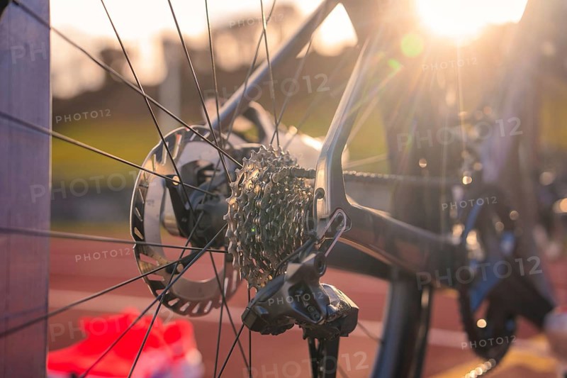 Rear wheel of a bicycle with gears at sunset on a track, triathlon bicycle, Calw, Germany