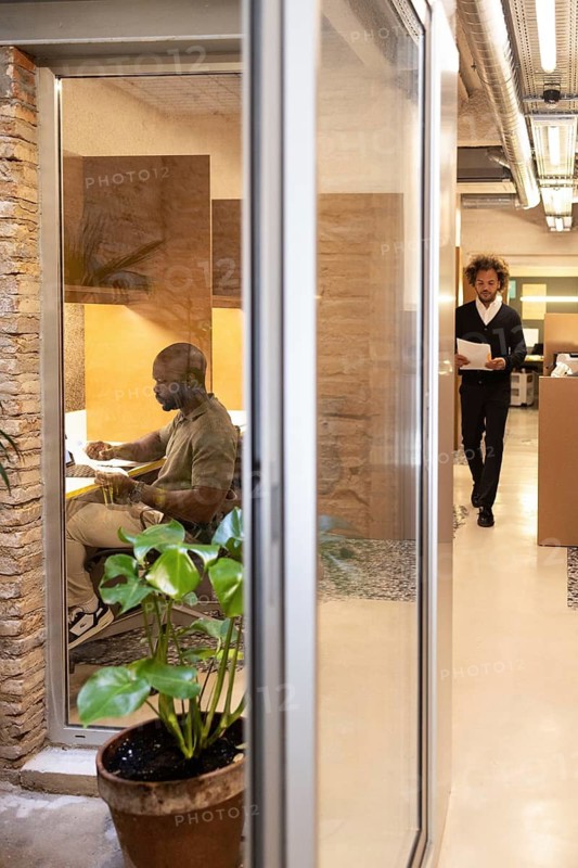 Experience a dynamic coworking environment in Barcelona, featuring a modern office setup. Professionals collaborate and innovate in a vibrant, stylish workspace filled with creativity