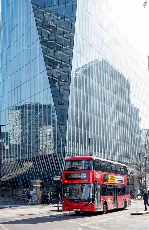London, UK. February 25th 2026. A red double decker London Transport bus passing modern high rise office buildings in the British capital city of London, UK