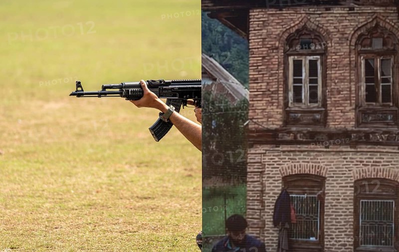 Personnel of the Central Reserve Police Force simulate an urban counter-terror operation, as they taking cover behind a mock building prop during a tactical drill at the 87th Raising Day celebrations, on February 19, 2026 in Guwahati, India