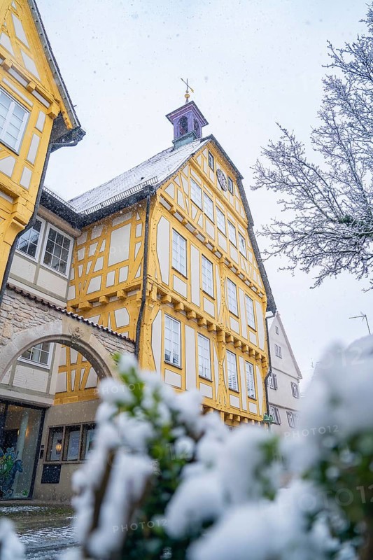 A large, yellow-painted half-timbered building stands out in the snow and displays splendid architecture, Sindelfingen, Germany
