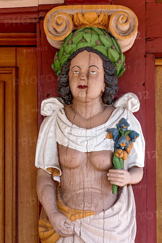 Atlant, figure of a woman with naked upper body, breasts, colourfully painted carving on the portal to the town hall, historic half-timbered house of the Renaissance, old town, Hadamar, Limburg-Weilburg, Westerwald, Hesse, Germany