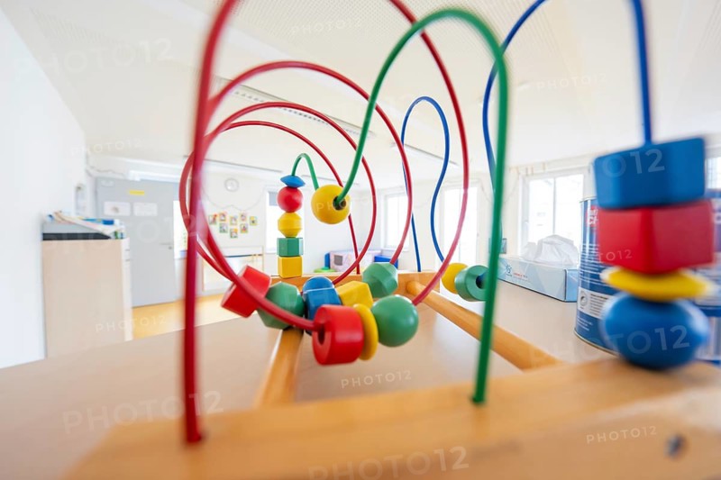 Wooden toy with colorful motor skills loops in a bright children's room, children's house, Calw, Germany