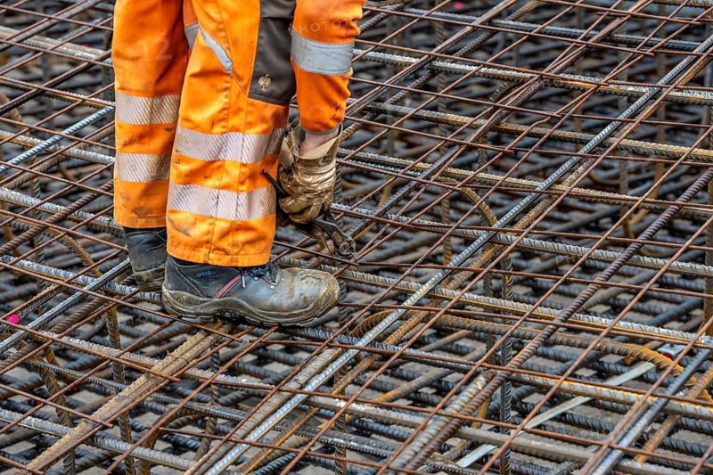 Assembly of reinforcing steel for the reinforced concrete foundation of a wind turbine, a mesh of rebar and reinforcing steel mesh, connecting the steel elements with binding wire, twisting with tongs, over 100 tons of reinforcing steel were used, the wind turbine will have a hub height of 160 meters, part of a new wind farm in Sauerland, near Balve, North Rhine-Westphalia, Germany