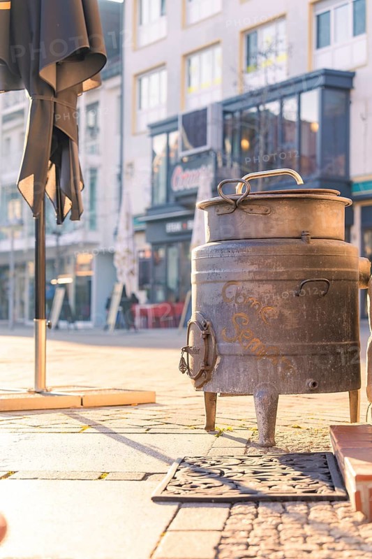 Retro metal pot in an old town street next to a café, Sindelfingen, Böblingen district, Germany