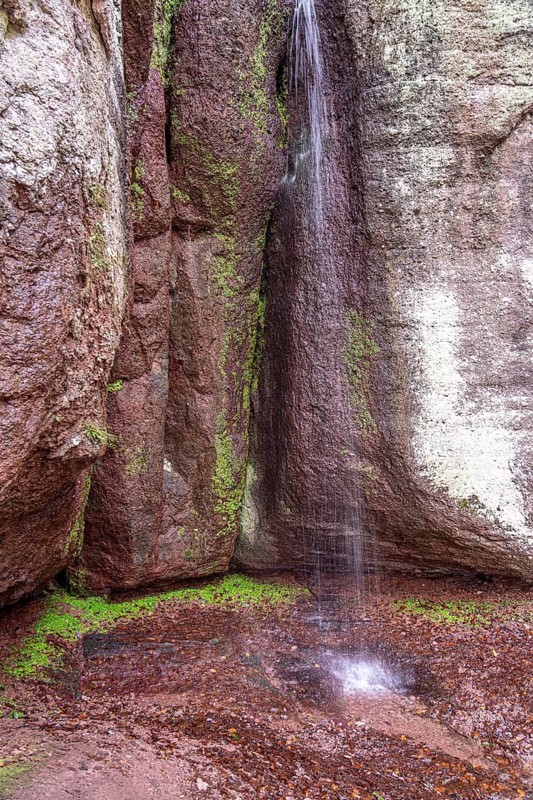 Fairy grotto with waterfall at the Dragon Gorge in Eisenach, Thuringia, Germany