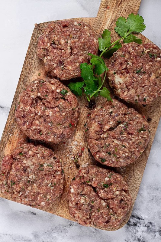 Raw cutlets, minced meat, on a chopping board, homemade, top view, no people