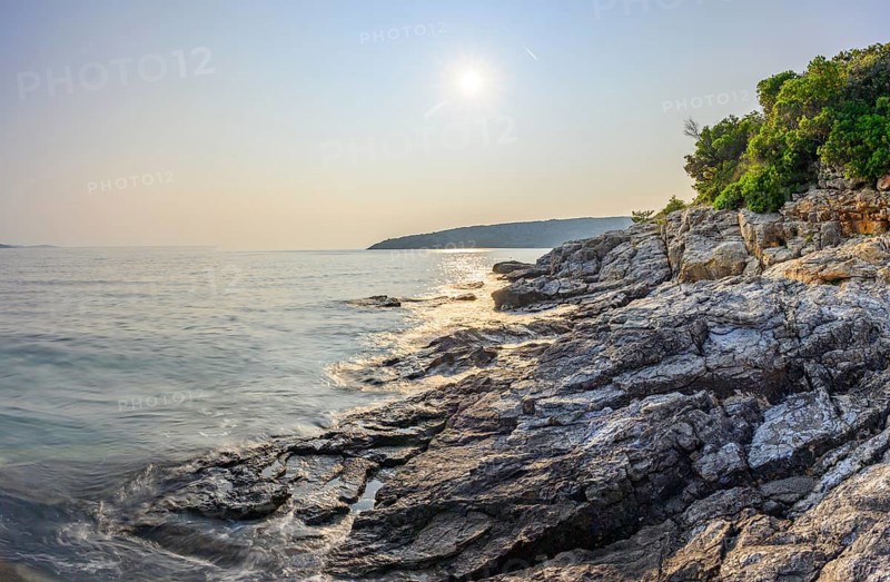 Crystal clear and turquoise water on the beach of Ustrine Bay on a sunny day at sunset on the island of Cres, long exposure, Croatia
