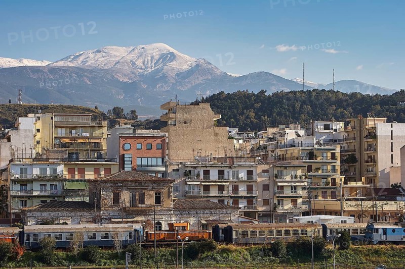 City skyline with densely built houses and snow-capped mountains in the background, old ferry port in the center of Patras, Ferries, Patras, Peloponnese, Greece