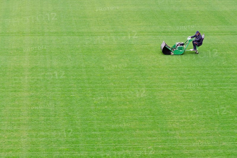 Mowing grass at the football pitch in Lubin, Poland