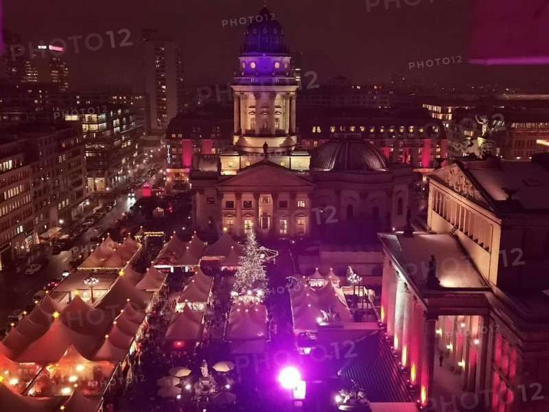 View from above of Christmas market at Gendarmenmarkt at night with vivid colors and glowing festive lights, Berlin